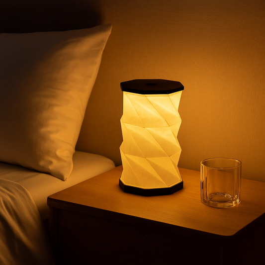 Foldable origami bedside lamp creating a cozy warm glow at night